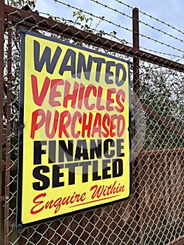 Ã¢â¬ËVehicles Purchased, Finance SettledÃ¢â¬â¢ Signage at a Used Car Forecourt photo